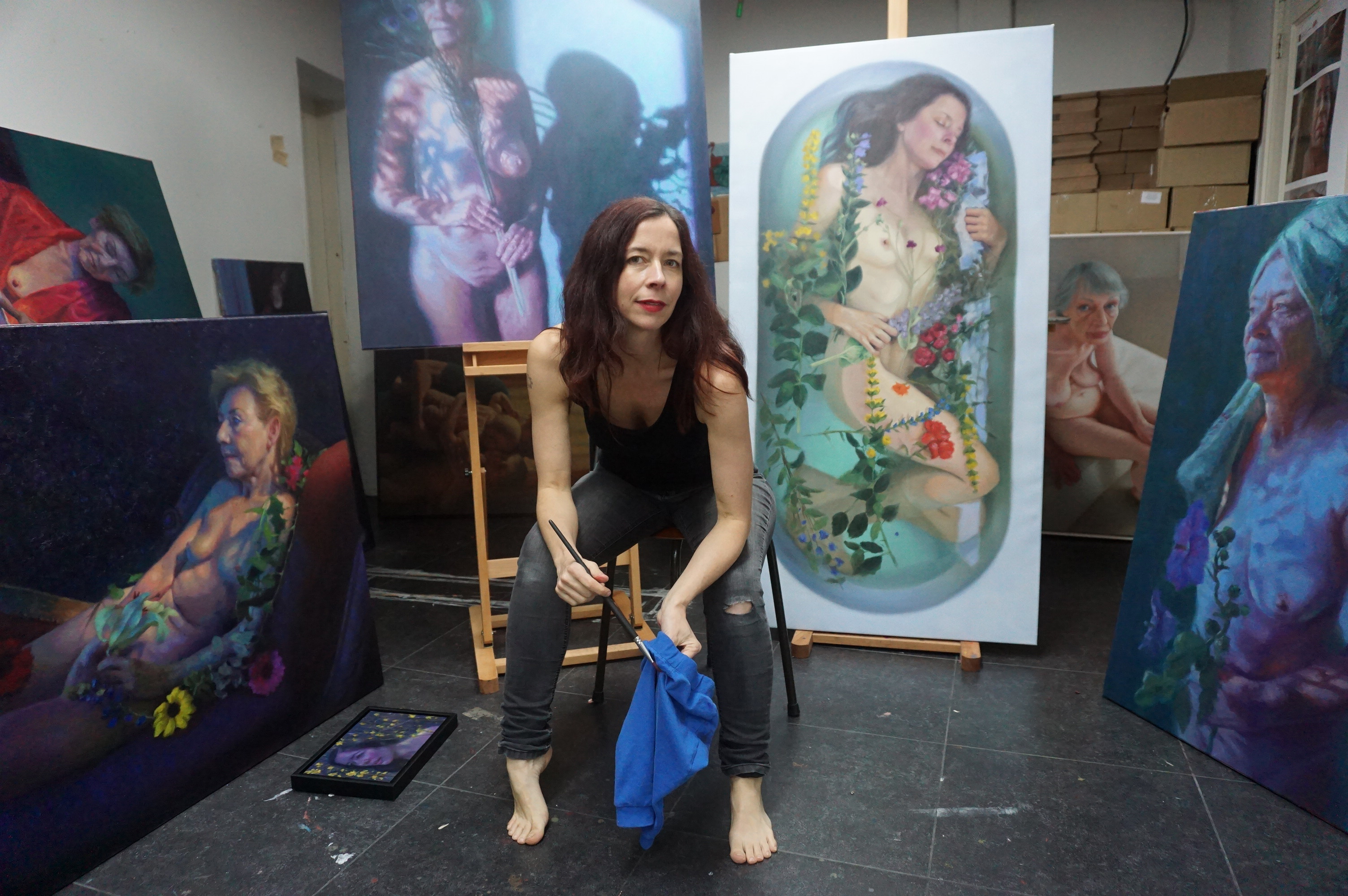Founder in her painting studio surrounded by her work